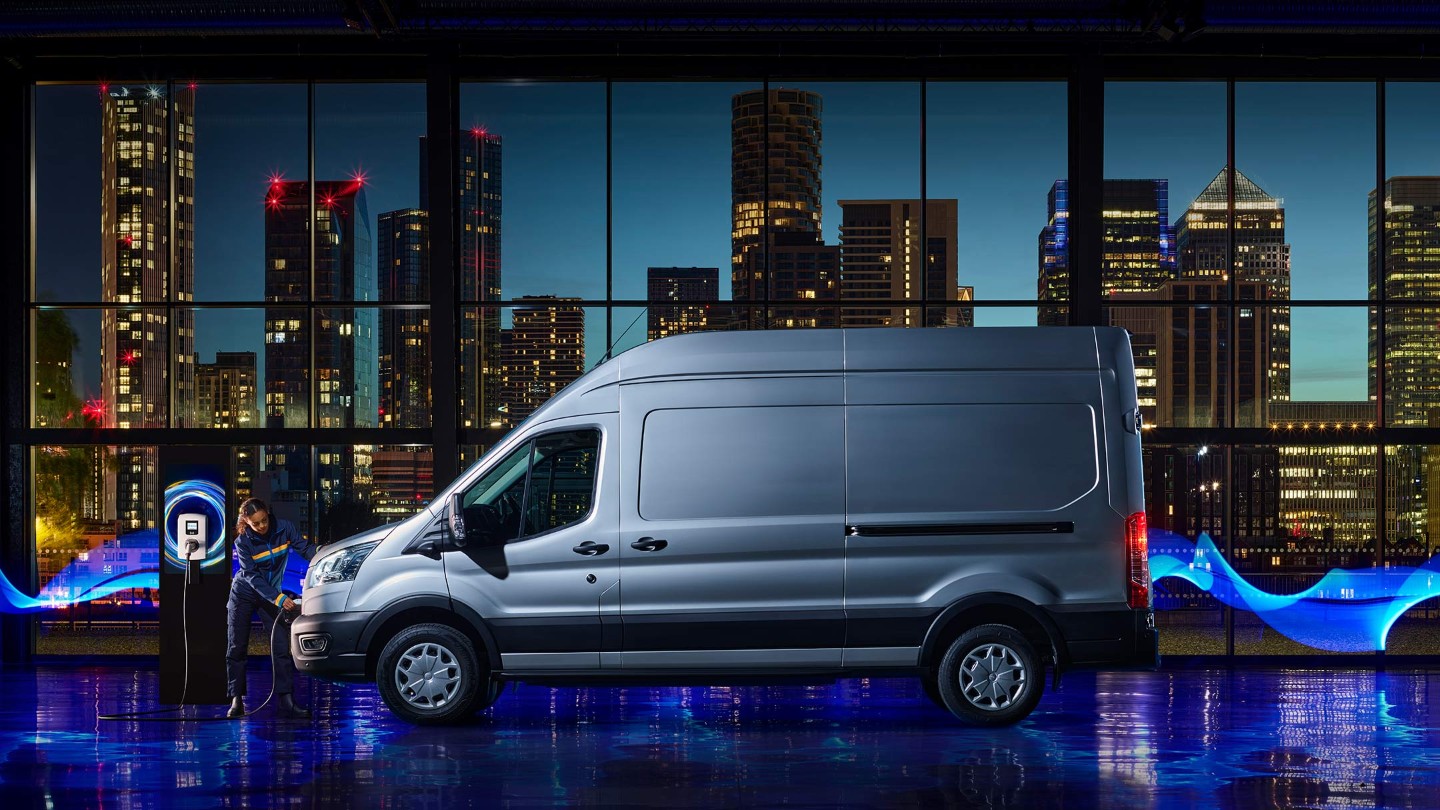 Ford Pro™ E-Transit side view, cityscape in background